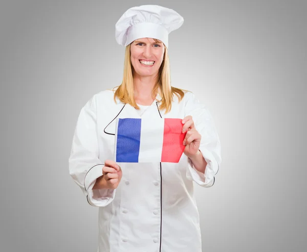 Glada kocken innehar franska flaggan — Stockfoto