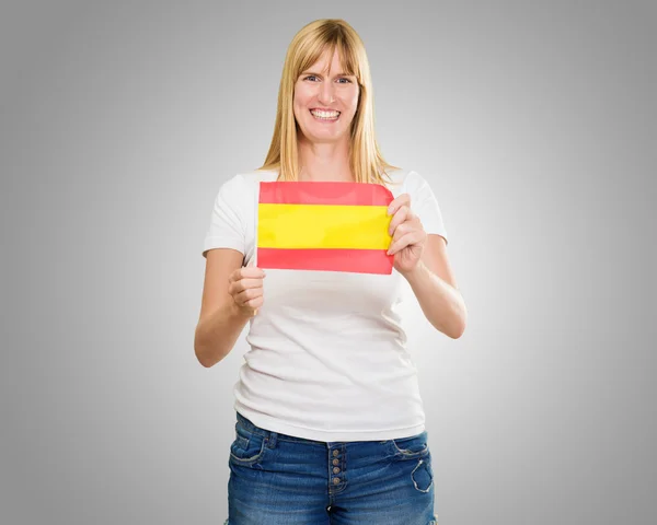 Mujer feliz sosteniendo bandera de España —  Fotos de Stock