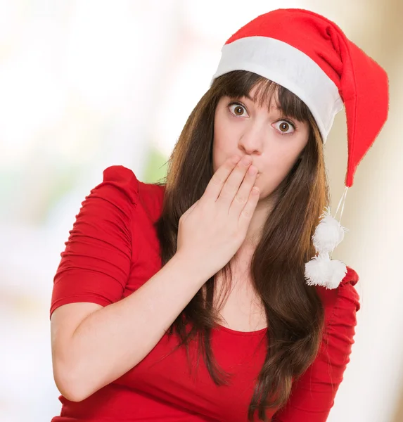 Mulher vestindo um chapéu de Natal e cobrindo a boca — Fotografia de Stock