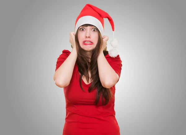 Scared woman wearing a christmas hat — Stock Photo, Image