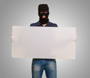 bir boş kartı tutan maskeli adam
