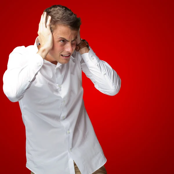 Portrait Of Young Man Covering His Ears With Hand — Stock Photo, Image