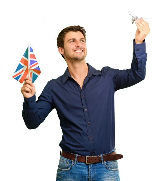 Bayrak ve uçak minyatür tutan adam — Stok fotoğraf