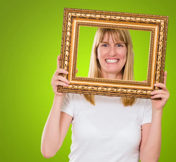 Mujer sosteniendo un marco de imagen —  Fotos de Stock