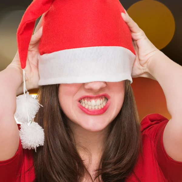 Angry woman with a christmas hat covering her eyes — Stock Photo, Image