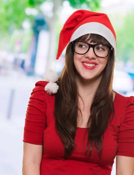 Ευτυχισμένη Χριστούγεννα γυναίκα φοράει γυαλιά και να ψάχνει σε μια πλευρά — Φωτογραφία Αρχείου