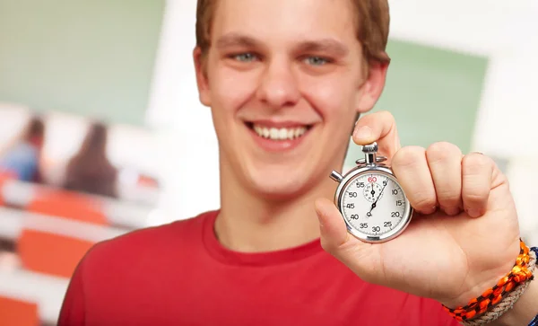 Portrait of a young man holding a stopwatch — Stock Photo, Image
