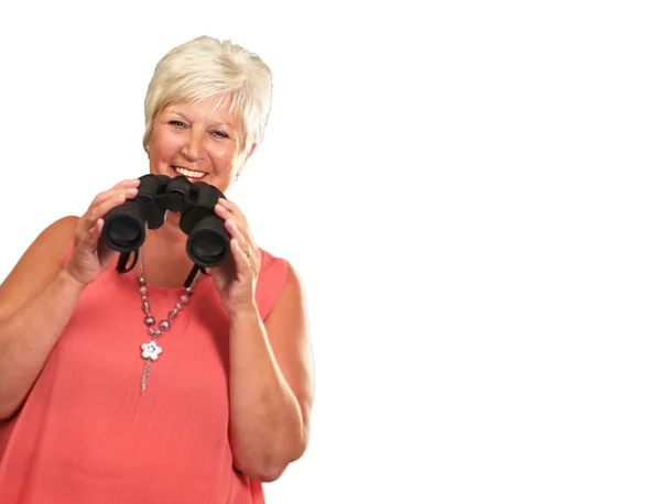 Starší žena držící dalekohled — Stock fotografie