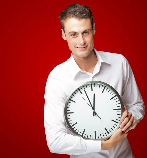 Happy Man Holding Clock In His Hand Royalty Free Stock Images