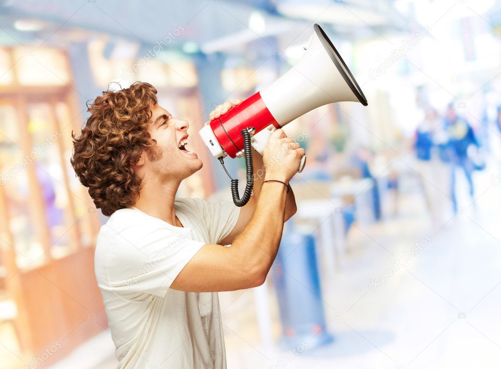 Portrait Of Young Man Shouting With A Megaphone