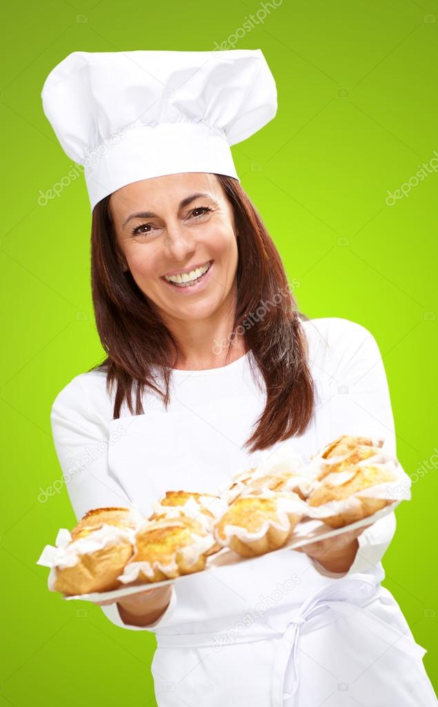 Woman chef holding baked food
