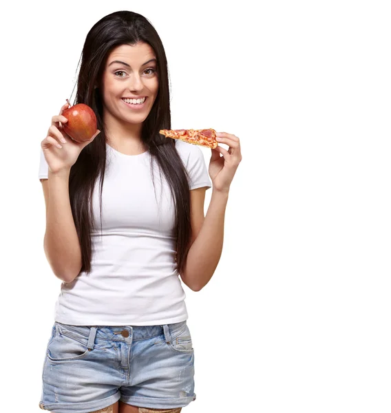 Feminino segurando um pedaço de pizza e uma maçã — Fotografia de Stock