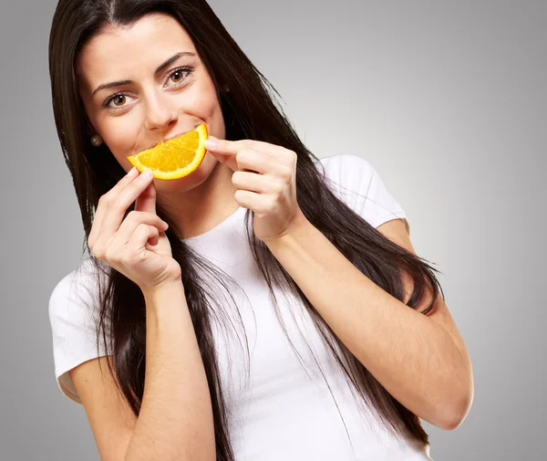 Young Girl Holding A Slice Of Orange Royalty Free Stock Images