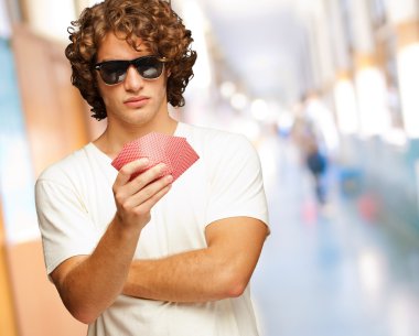 A Man Holding Few Playing Cards