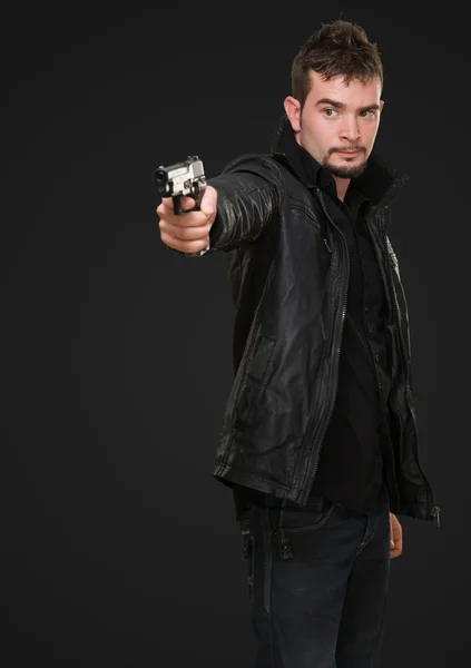 Handsome man pointing with gun — Stock Photo, Image