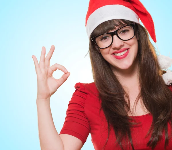 Christmas woman doing an ok gesture — Stock Photo, Image