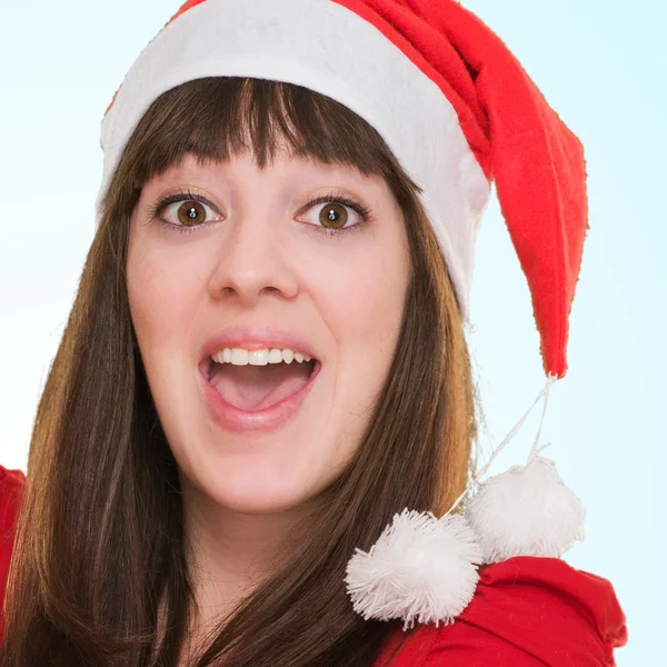 Surprised woman wearing a christmas hat and holding a balloon — Stock Photo, Image