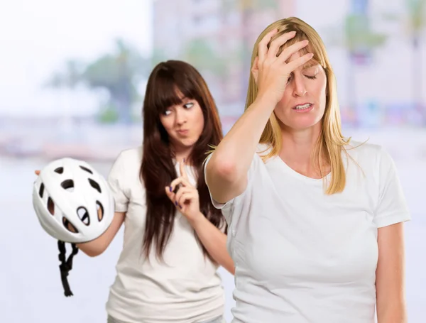 Woman Holding Safety Helmet In Front Of Unhappy Woman — Stock Photo, Image