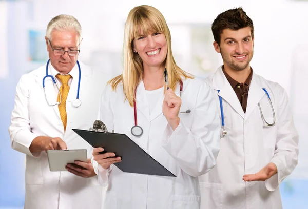 Happy Female Doctor Holding Clipboard Infront Of Male Doctor — Stock Photo, Image