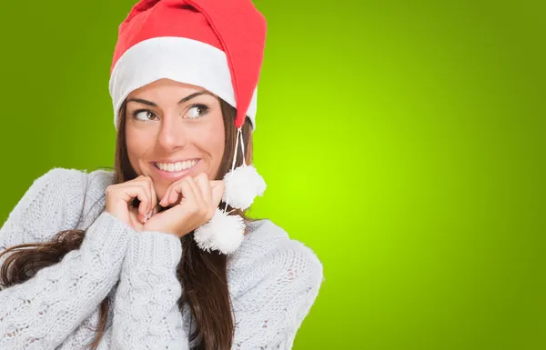 Woman wearing a christmas hat and thinking Stock Photo