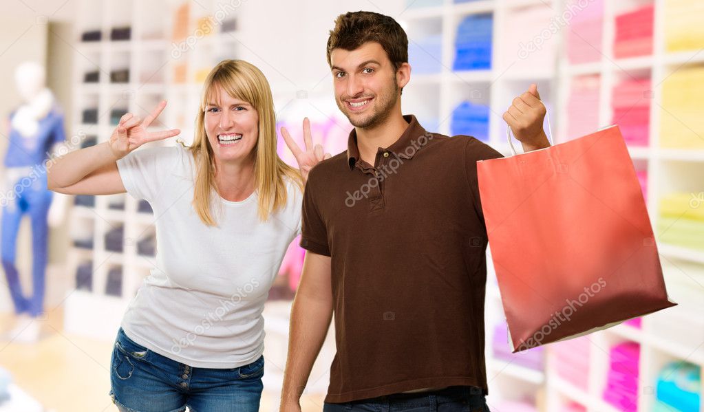 Man Holding Shopping Bag Infront Of Happy Woman