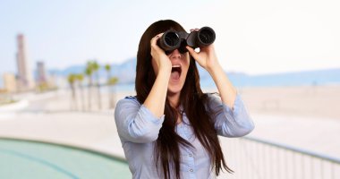 Portrait Of A Young Woman Looking Through Binoculars clipart