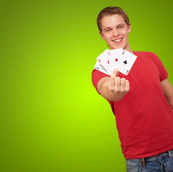 Portrait of a young male holding four aces — Stock Photo, Image