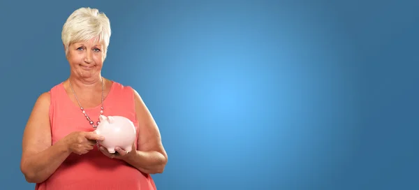 Woman Putting Coin In Piggy Bank — Stock Photo, Image