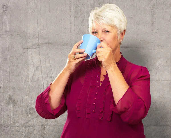 Senior Woman Drinking From Cup — Stock Photo, Image