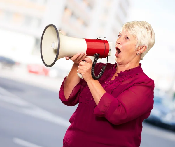 Retrato de uma mulher sênior com megafone — Fotografia de Stock