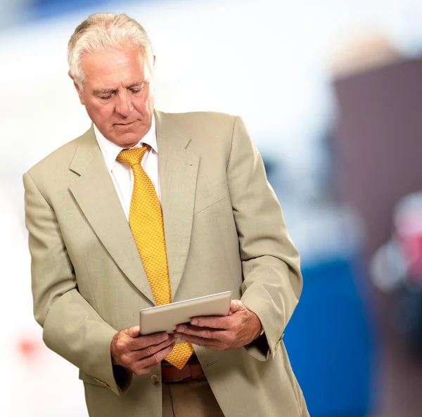 Portret van een senior man aan het werk op een laptop — Stockfoto