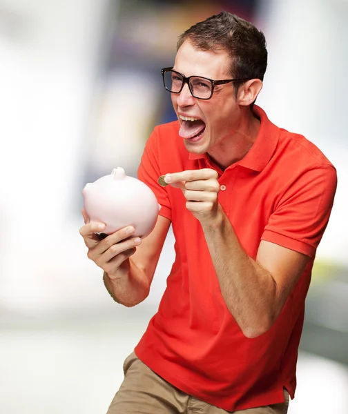 Portrait Of Man With Piggy Bank Inserting A Coin — Stock Photo, Image