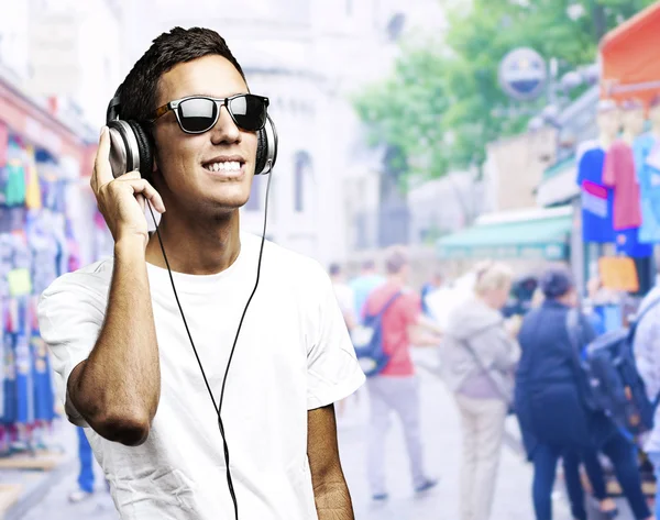 Portrait of a young boy listening to music — Stock Photo, Image