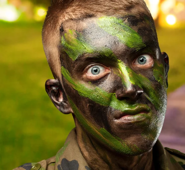 Closeup of angry soldier with painting — Stock Photo, Image