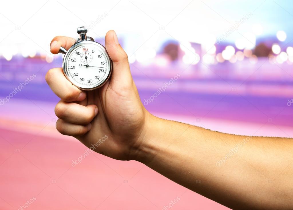 Close Up Of Hand Holding Stopwatch