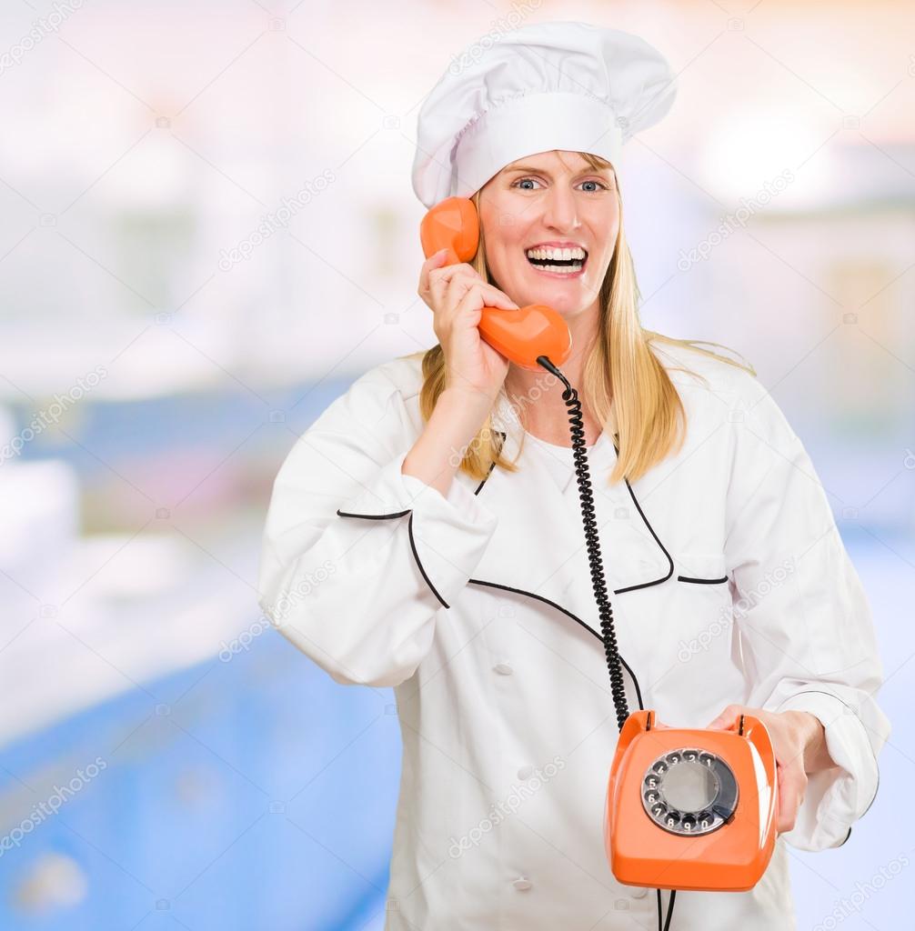 Female Chef Holding Telephone