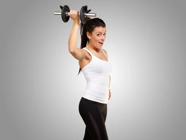 Portrait of a young pretty woman holding weights and doing fitne — Stock Photo, Image