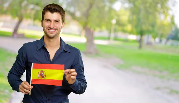 Ung man håller Spanien flagga — Stockfoto