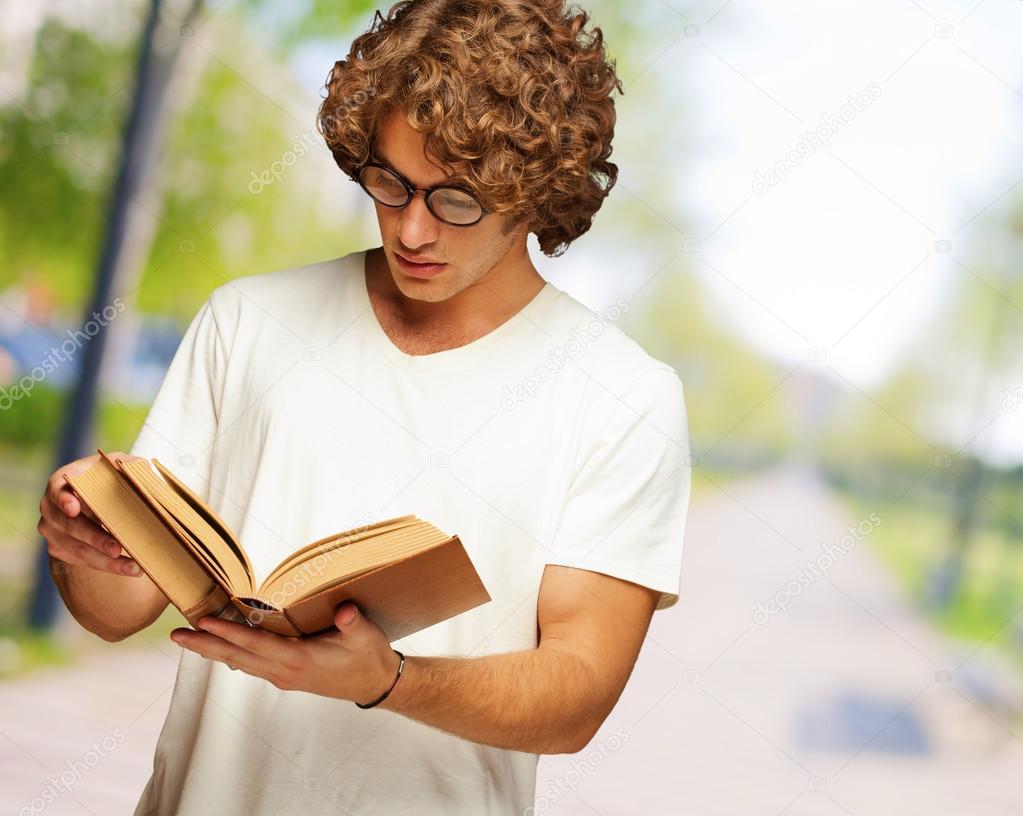 Young Man Reads A Book