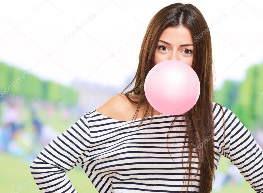 Portrait Of A Young Woman Blowing Bubblegum