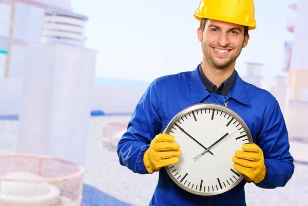 Happy Engineer Holding Wall Clock — Stock Photo, Image