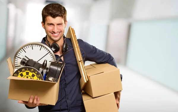 Ung man håller cardboxes gester — Stockfoto