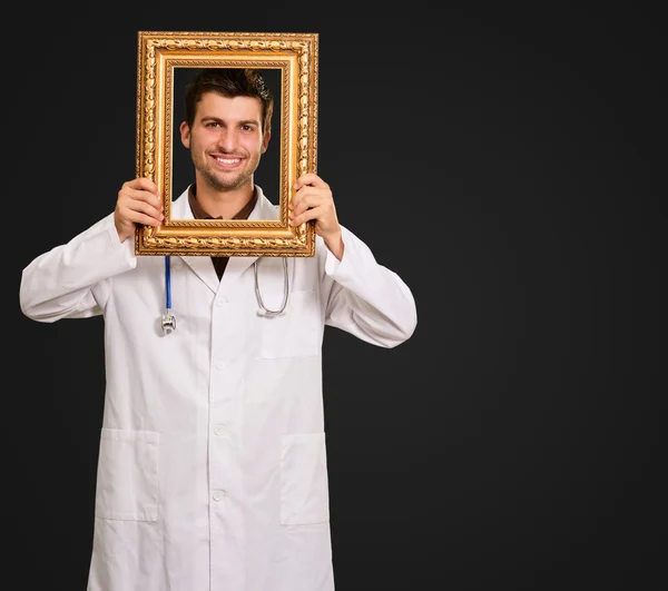 Young Doctor Holding Frame — Stock Photo, Image