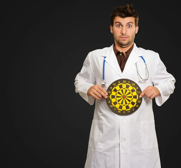 Expressive Young Doctor Holding Bulls Eye — Stock Photo, Image
