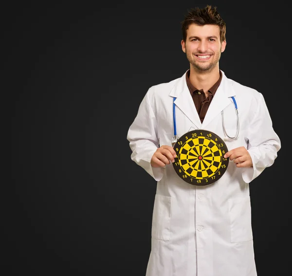 Happy Young Doctor Holding Bulls Eye — Stock Photo, Image