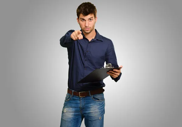 Retrato del hombre sosteniendo portapapeles y gestos — Foto de Stock