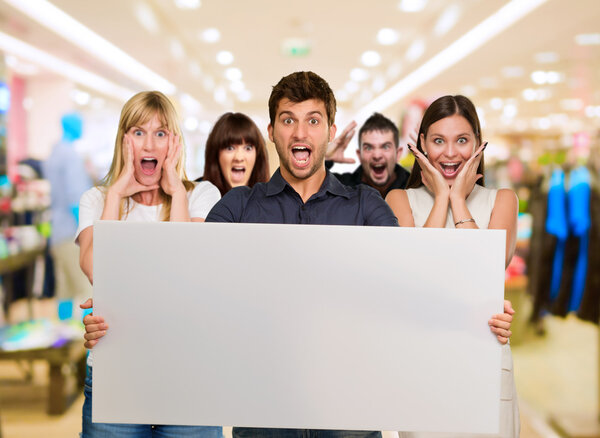 Man Holding Blank Placard And Woman Screaming From Behind