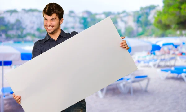 Young Man Holding Banner Gesturing — Stock Photo, Image