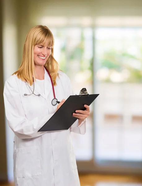 Portrait Of Happy Doctor Writing on Clipboard — стоковое фото