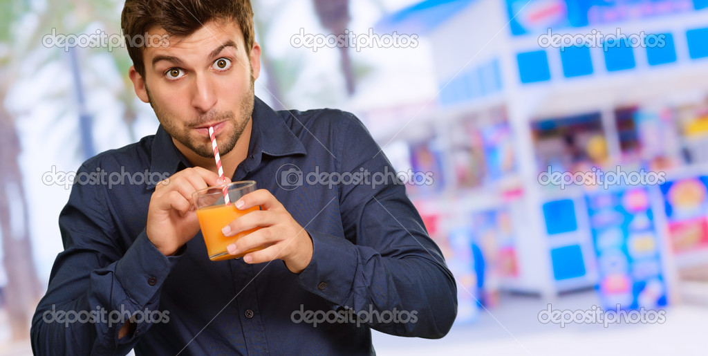 Young Man Sipping Juice Through Straw